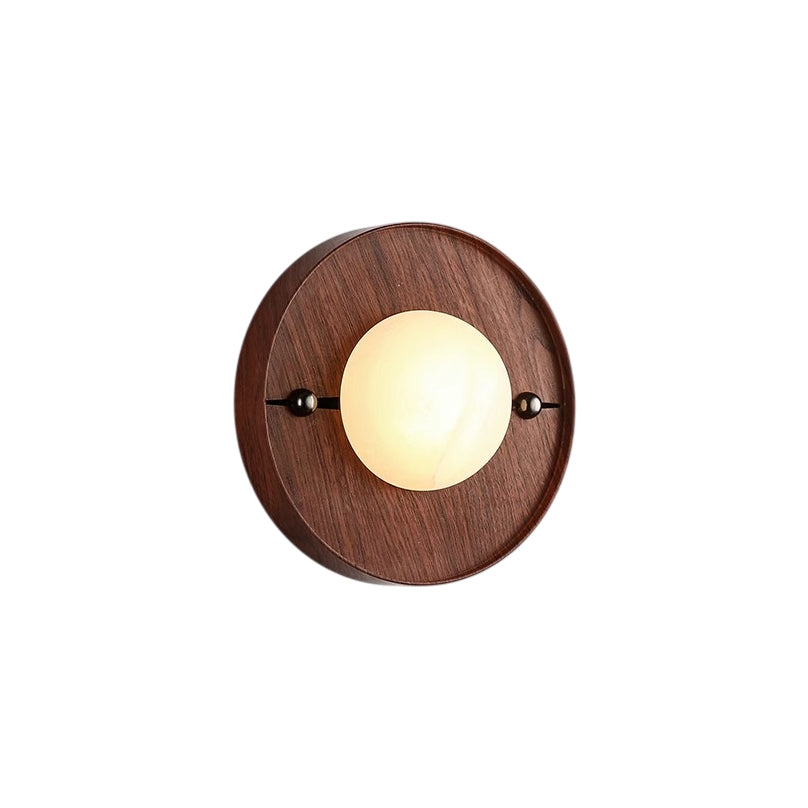 Round Odis wall lamp with a walnut-color surround and illuminated alabaster center
